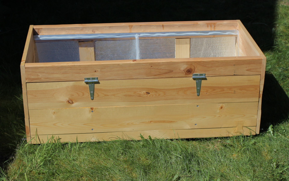 Fig.5 - Exterior view of the outer shell and one of the doors that allow observation of the colony. Silicone caulking affixes the glass panes to the metal rails.